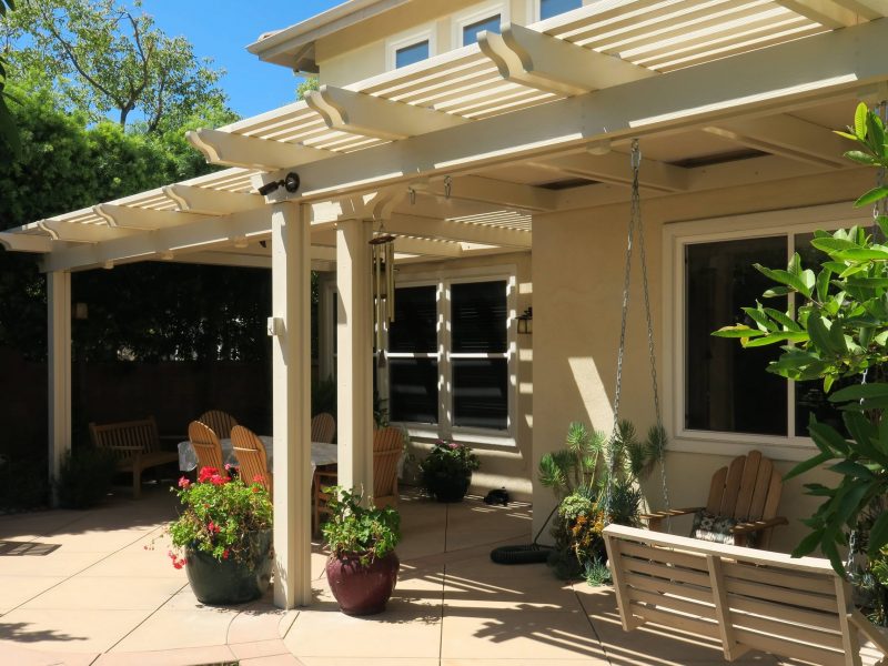 Exterior of Combination Open Lattice & Solid Insulated Patio Cover with brick columns facing the home.